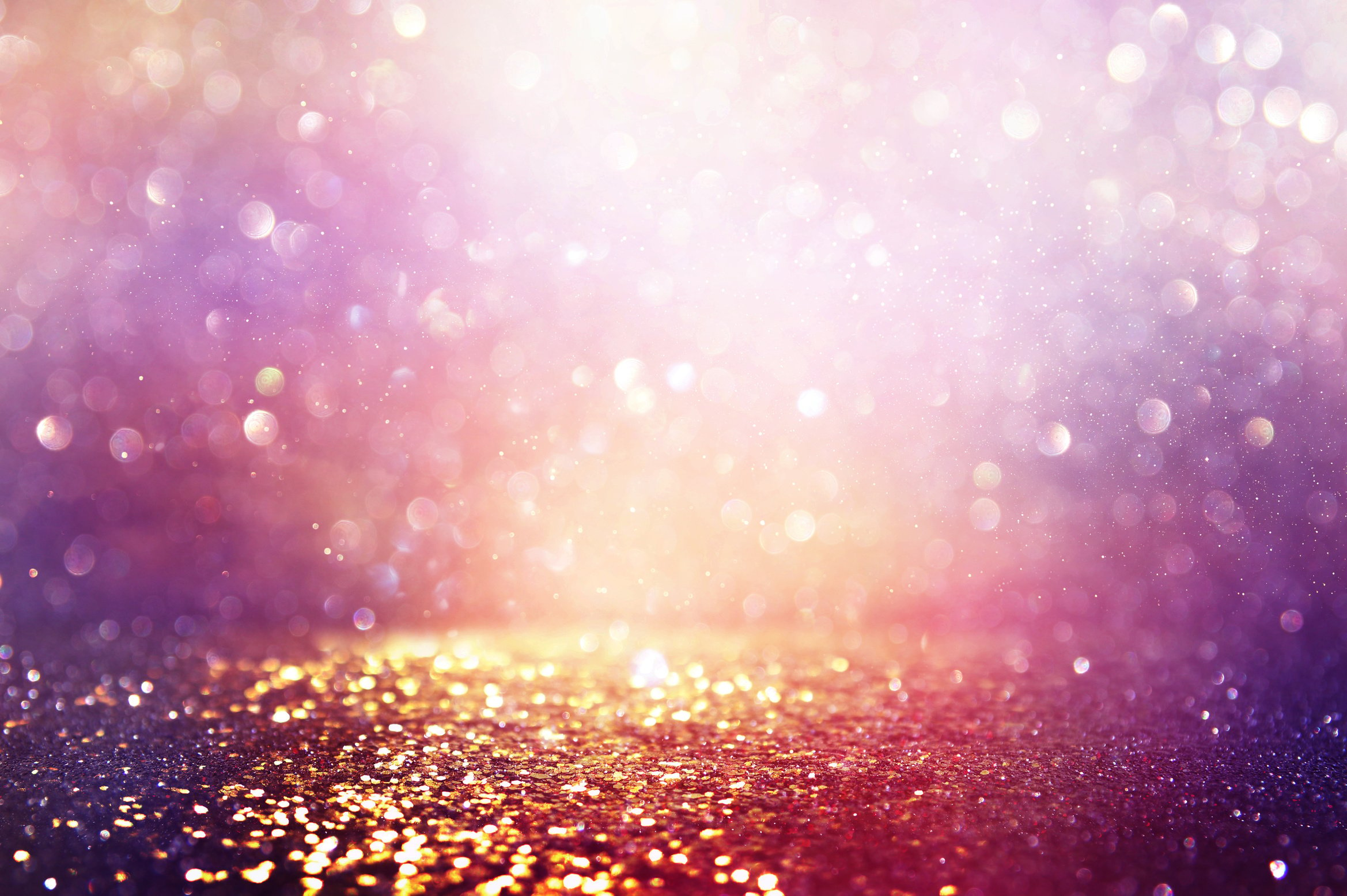 abstract glitter pink, purple and gold lights background. de-focused